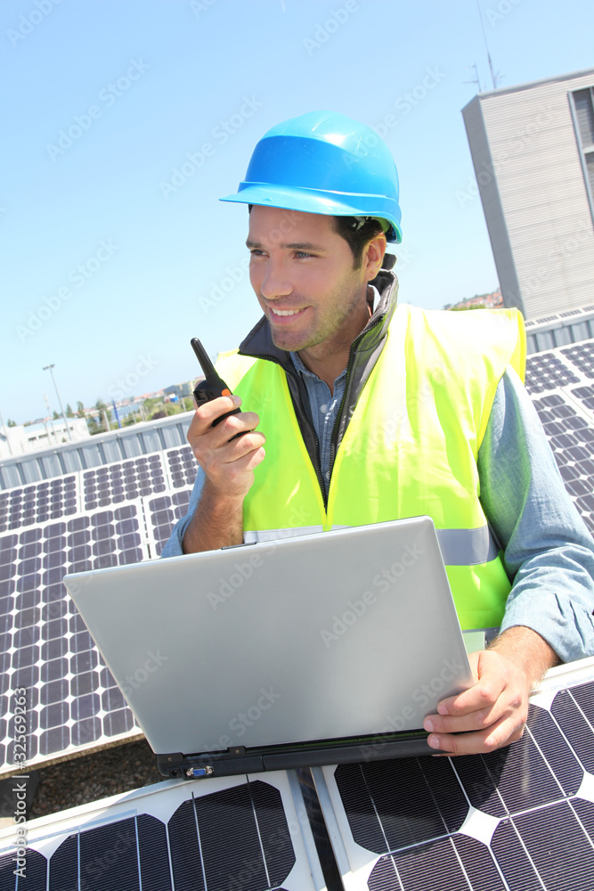 Engineer with walkie-talkie on photovoltaic installation Engineer with walkie-talkie on photovoltaic installation