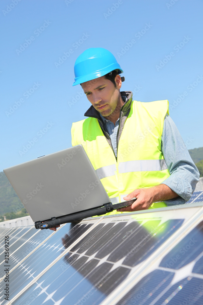 Engineer checking photovoltaic installation Engineer checking photovoltaic installation
