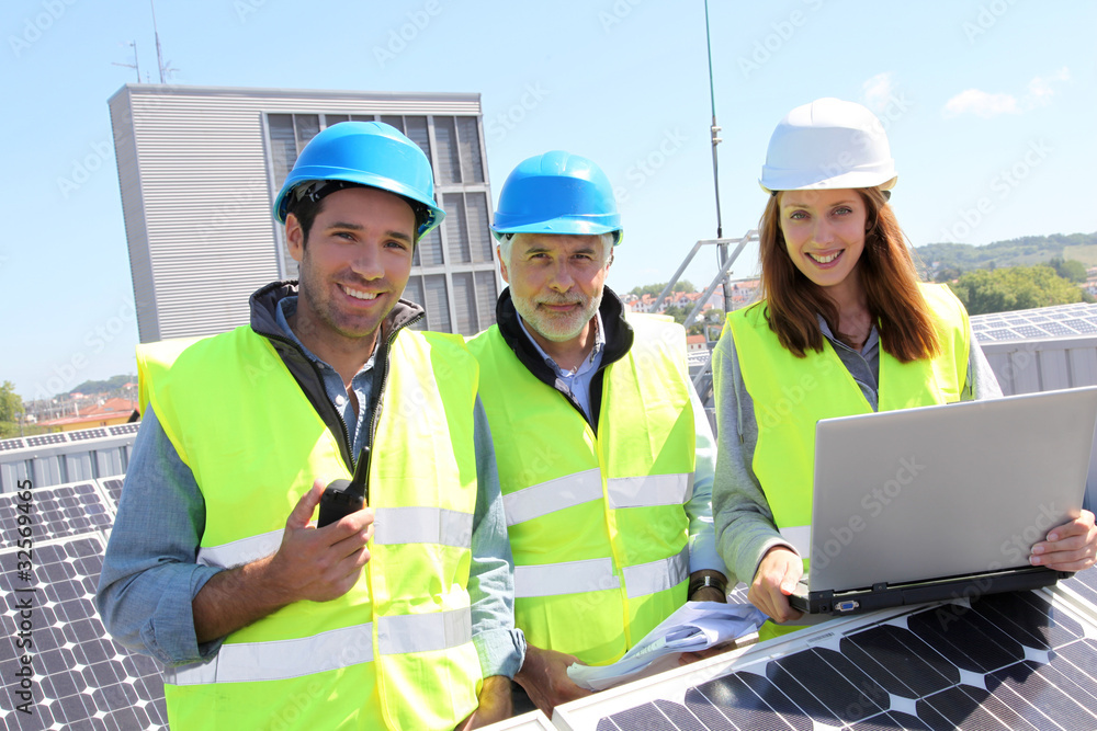 Group of engineers meeting on building roof Group of engineers meeting on building roof