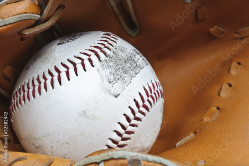 Photography Close up of baseball in catcher's mittt with shallow depth of fi