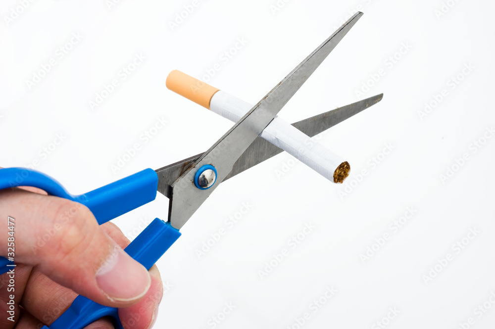 A hand cutting cigarette A hand cutting cigarette