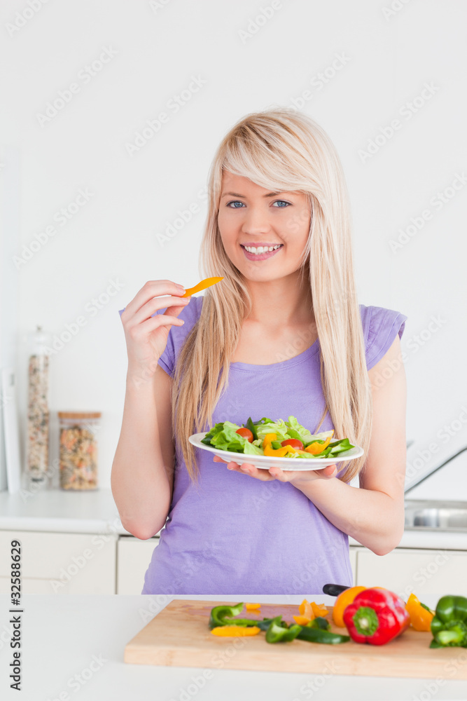 Attractive smiling female eating her salad Attractive smiling female eating her salad