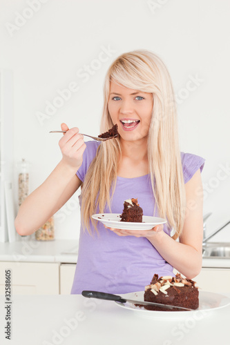 Beautiful caucasian female eating cake