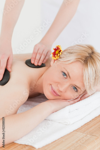 Attractive woman receiving a massage with hot stones