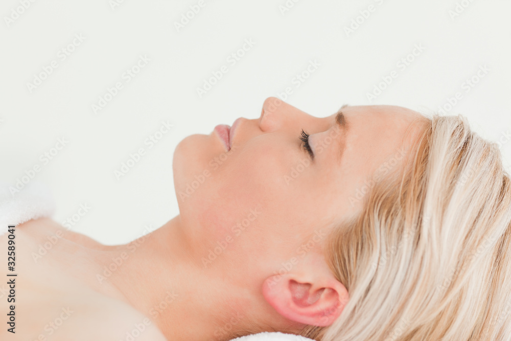 Attractive blond-haired woman relaxing while lying down Attractive blond-haired woman relaxing while lying down