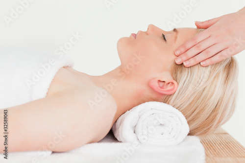 Pretty blonde woman enjoying her treatment in a Spa centre