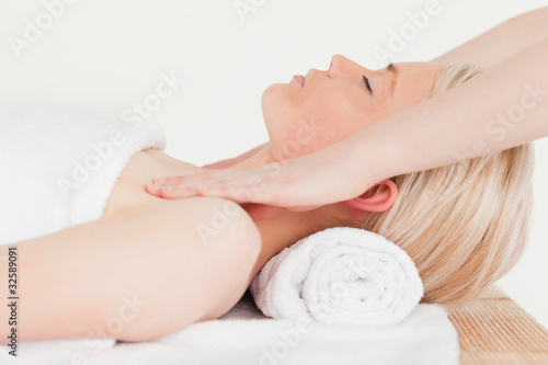Delighted blonde woman enjoying her treatment in a Spa centre