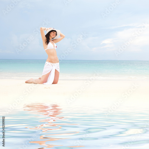 Young fashion woman on the beach