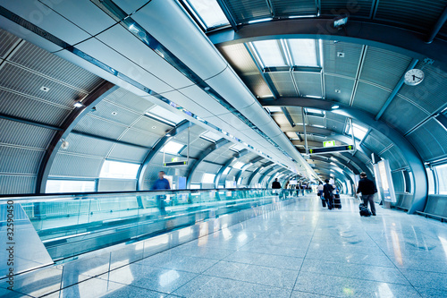 Fotografie, Obraz futuristic airport terminal with blurred passengers
