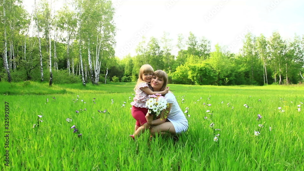 Mother and baby cuddling in the grass. Dolly HD Mother and baby cuddling in the grass. Dolly HD