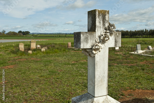 Marble cross in rural graveyard