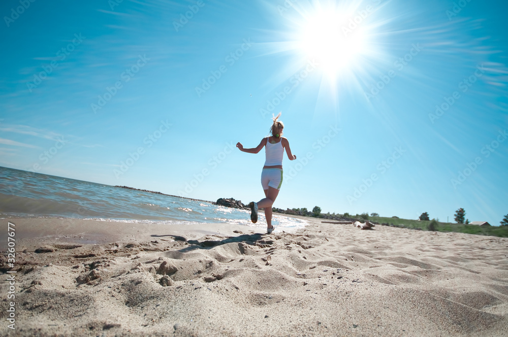 Sport woman running in sea coast Sport woman running in sea coast
