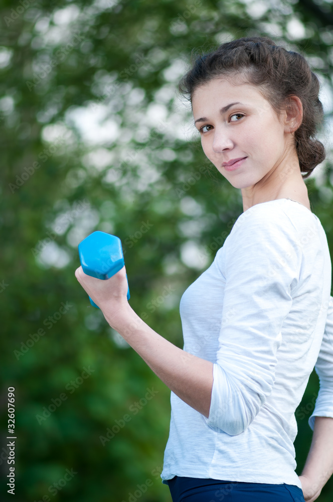 woman doing exercise with dumbbell woman doing exercise with dumbbell