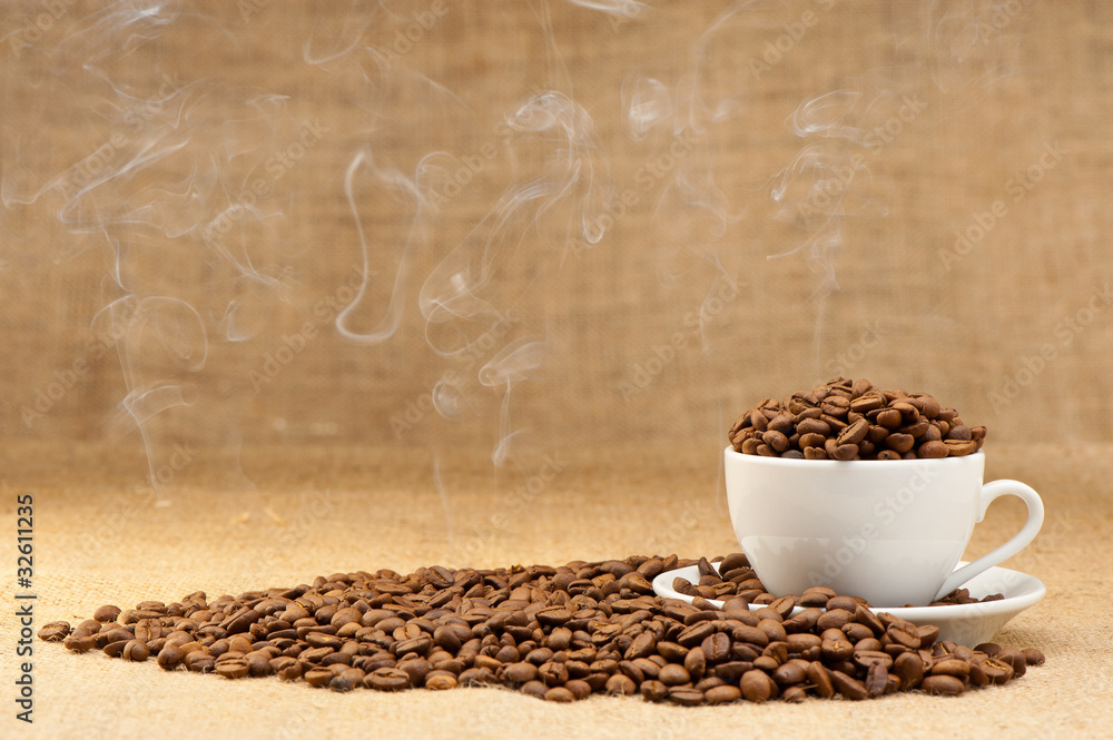 Cup with grains of coffee and a smoke. Cup with grains of coffee and a smoke.