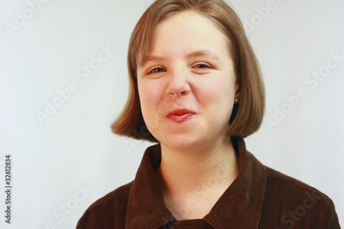 Young girl with puckered red lips and short brown hair.