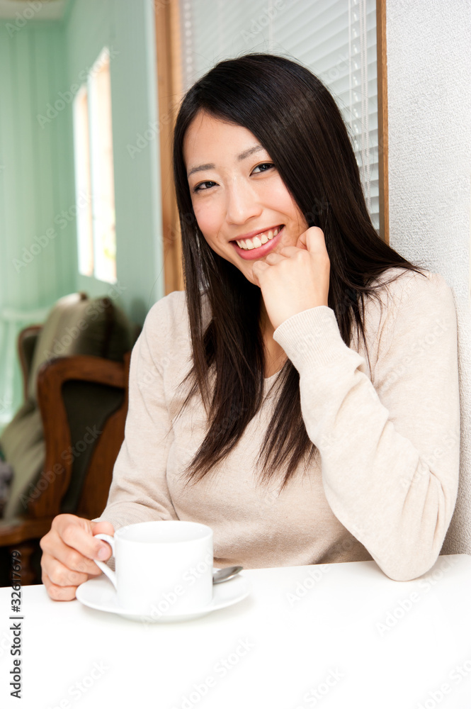 beautiful asian woman drinking a cup of coffee beautiful asian woman drinking a cup of coffee