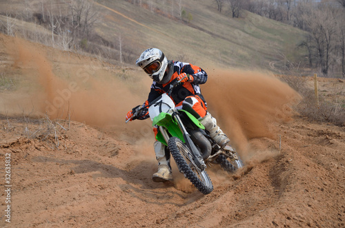 Motocross rider with a strong slope turns sharply