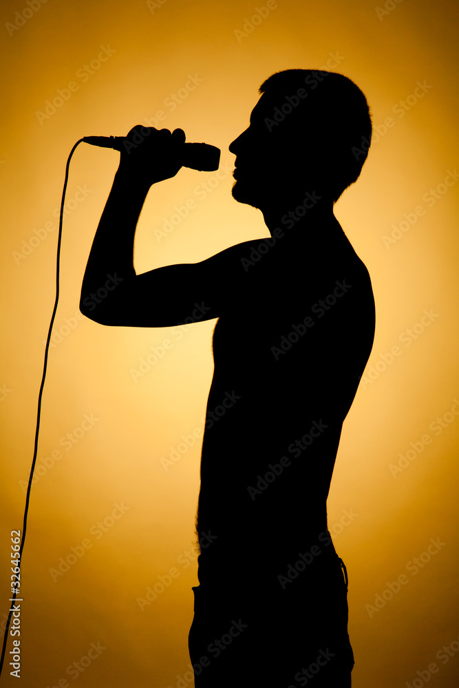 Silhouette of a young man in orange.