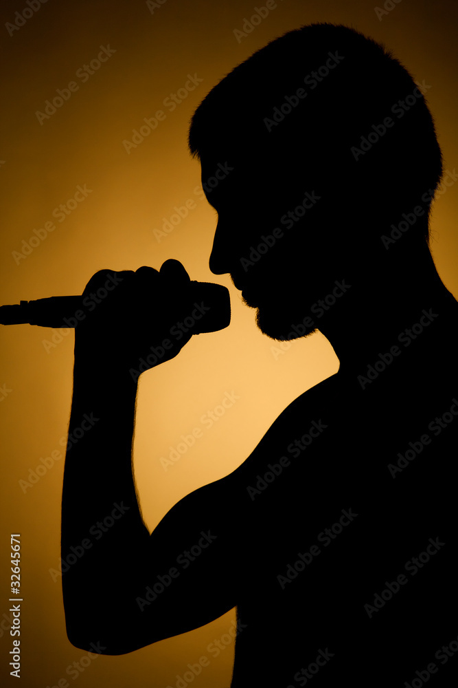 Silhouette of a young man in orange. Silhouette of a young man in orange.