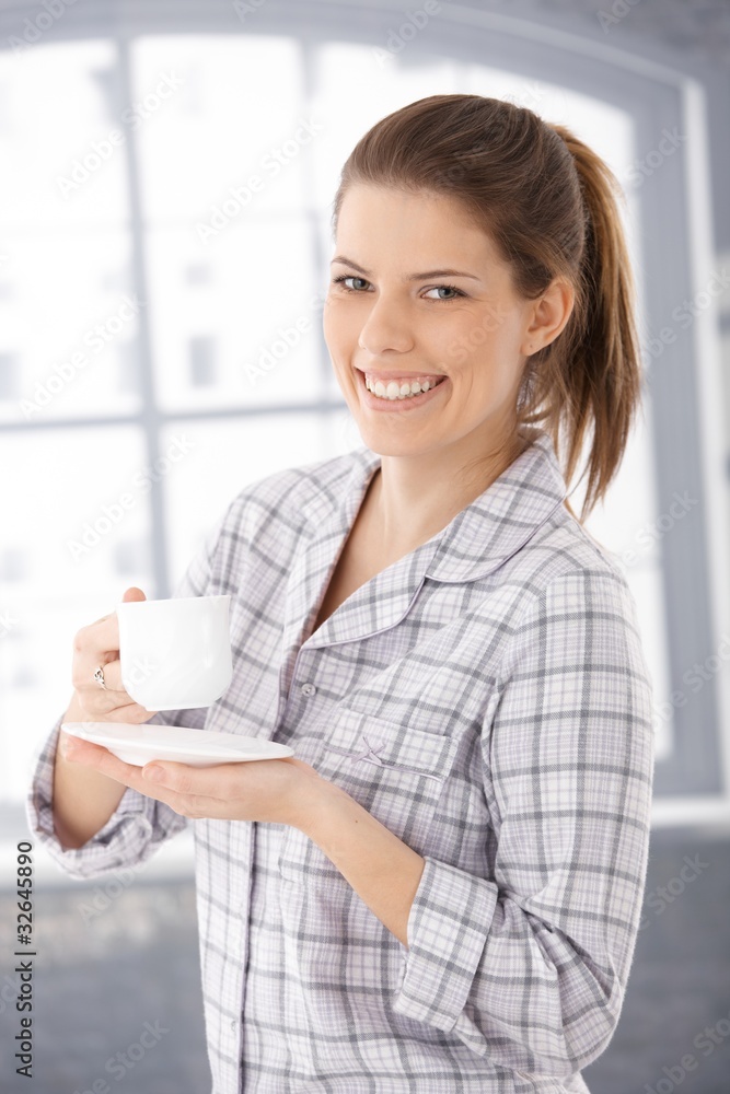 Happy woman in pyjama with coffee cup Happy woman in pyjama with coffee cup