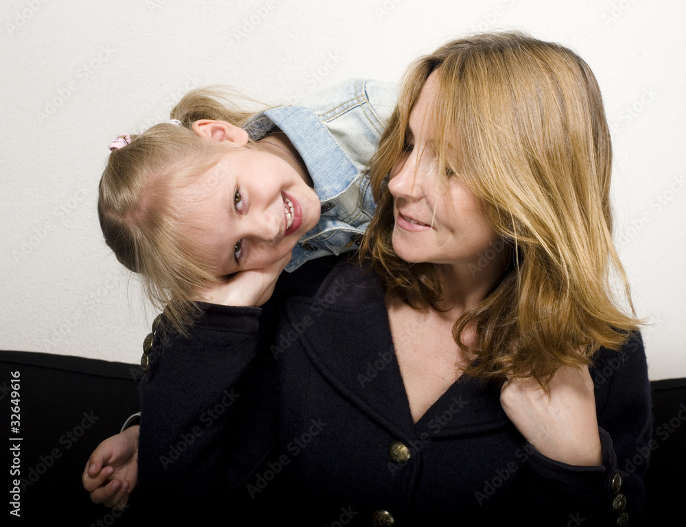 portrait of happy mother with daughter hugging portrait of happy mother with daughter hugging