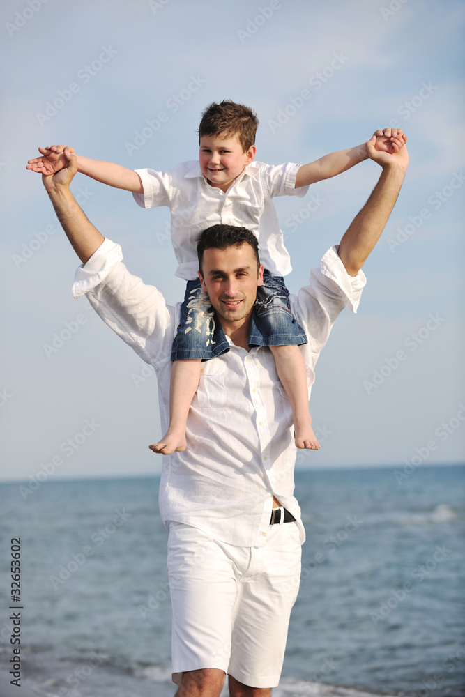 happy father and son have fun and enjoy time on beach happy father and son have fun and enjoy time on beach