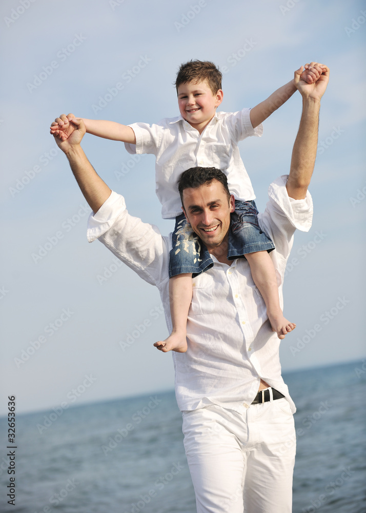 happy father and son have fun and enjoy time on beach happy father and son have fun and enjoy time on beach
