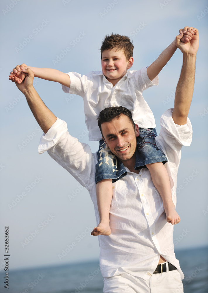 happy father and son have fun and enjoy time on beach happy father and son have fun and enjoy time on beach
