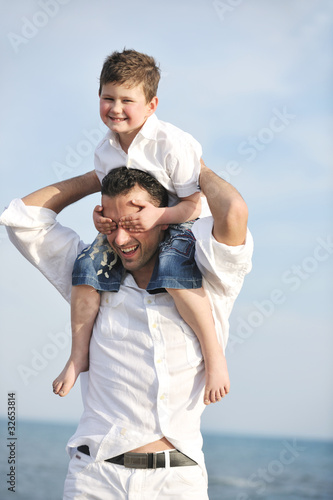 happy father and son have fun and enjoy time on beach © .shock