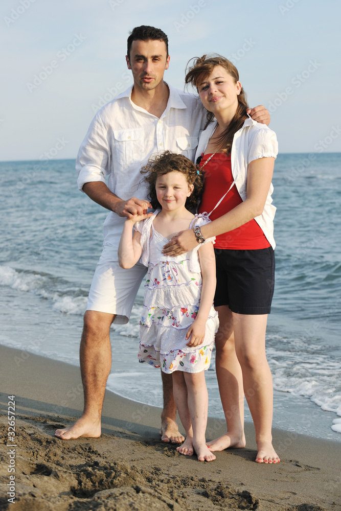 happy young family have fun on beach happy young family have fun on beach