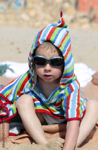 Little Boy in towel on beach