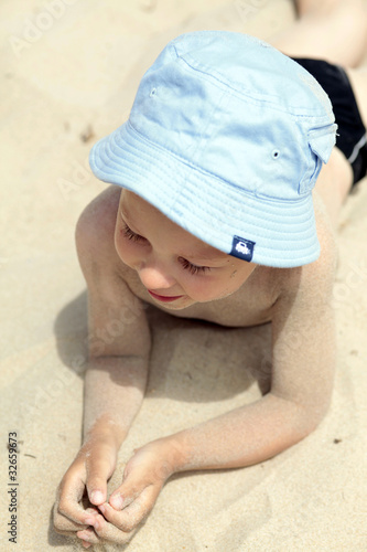 Boy lying on sand