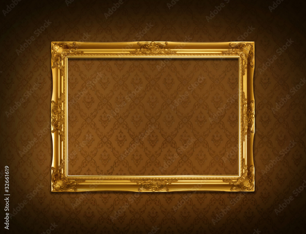 Gold frame stuck on the wall wallpaper thai the dark. Stock Photo
