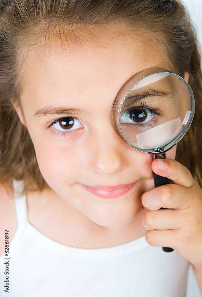 little girl looking through a magnifying glass little girl looking through a magnifying glass