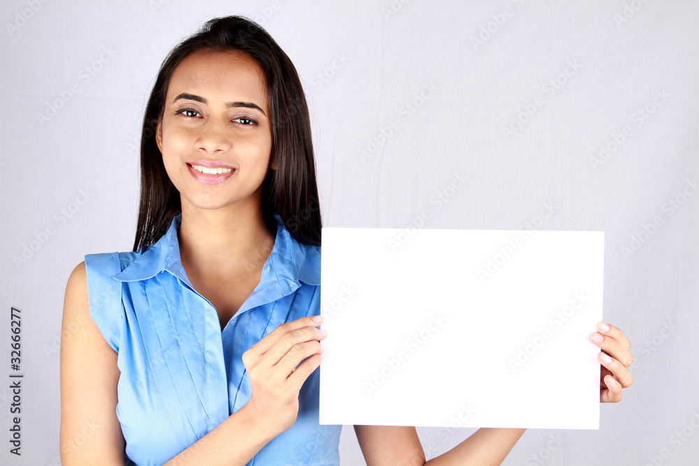 Young business woman holding empty white board. Young business woman holding empty white board.