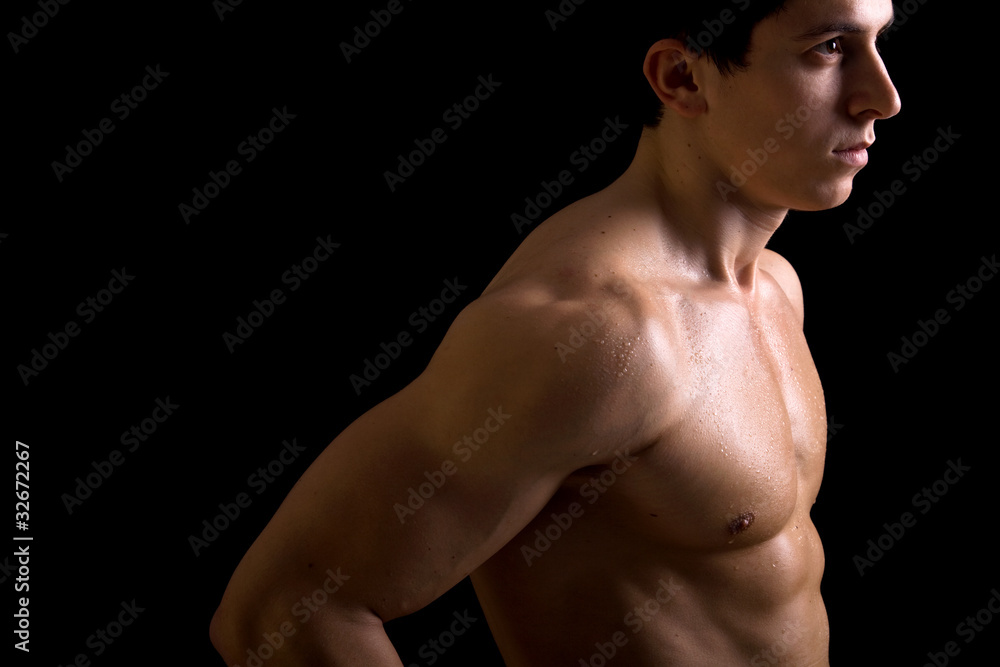 Muscular male torso on black background Muscular male torso on black background