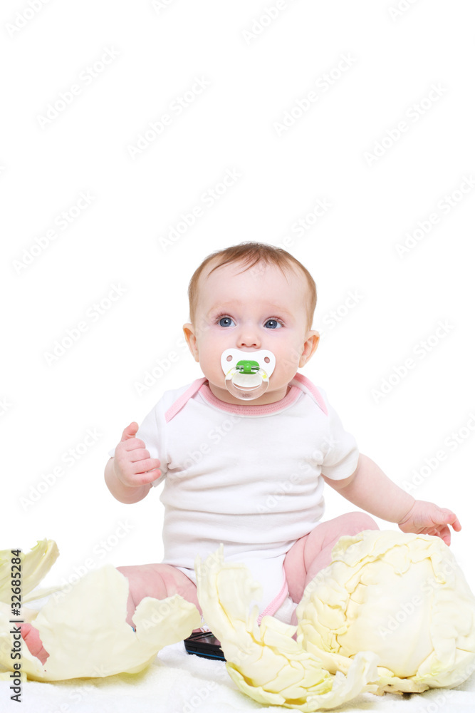 eight-monthly baby sits in cabbage leaves eight-monthly baby sits in cabbage leaves