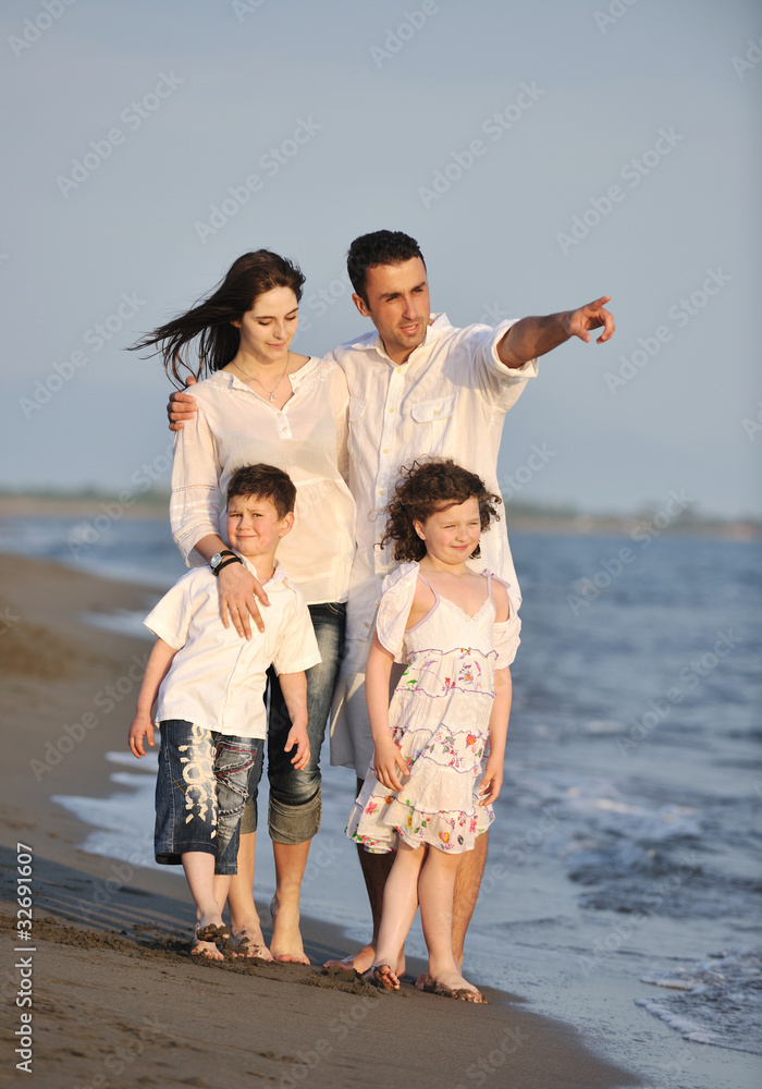 happy young family have fun on beach at sunset happy young family have fun on beach at sunset