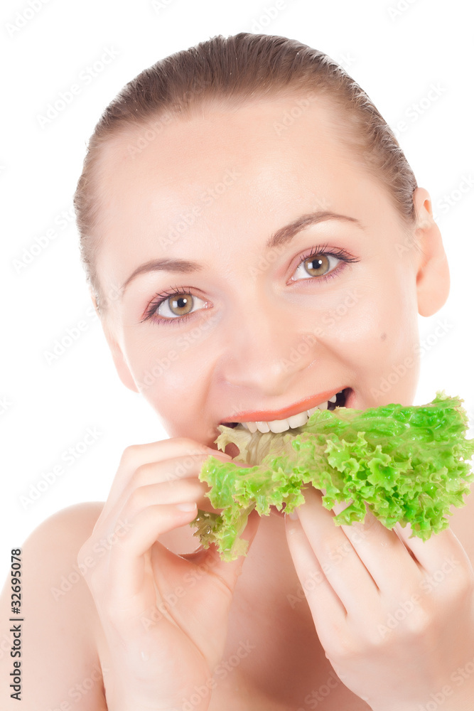 Pretty model holding a lettuce leaf close to lips Pretty model holding a lettuce leaf close to lips