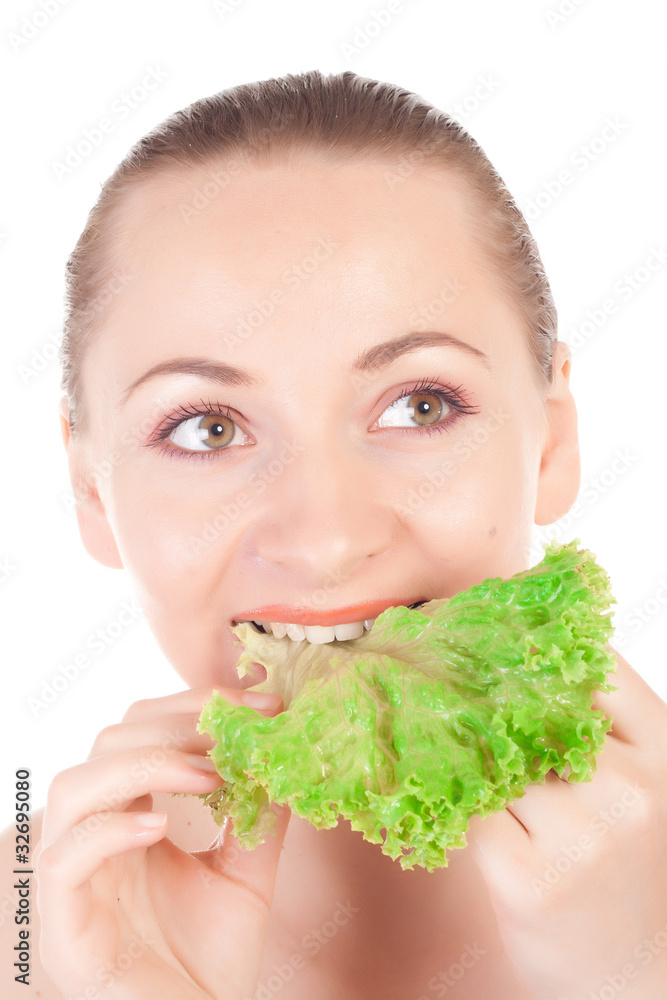 Pretty model holding a lettuce leaf close to lips Pretty model holding a lettuce leaf close to lips