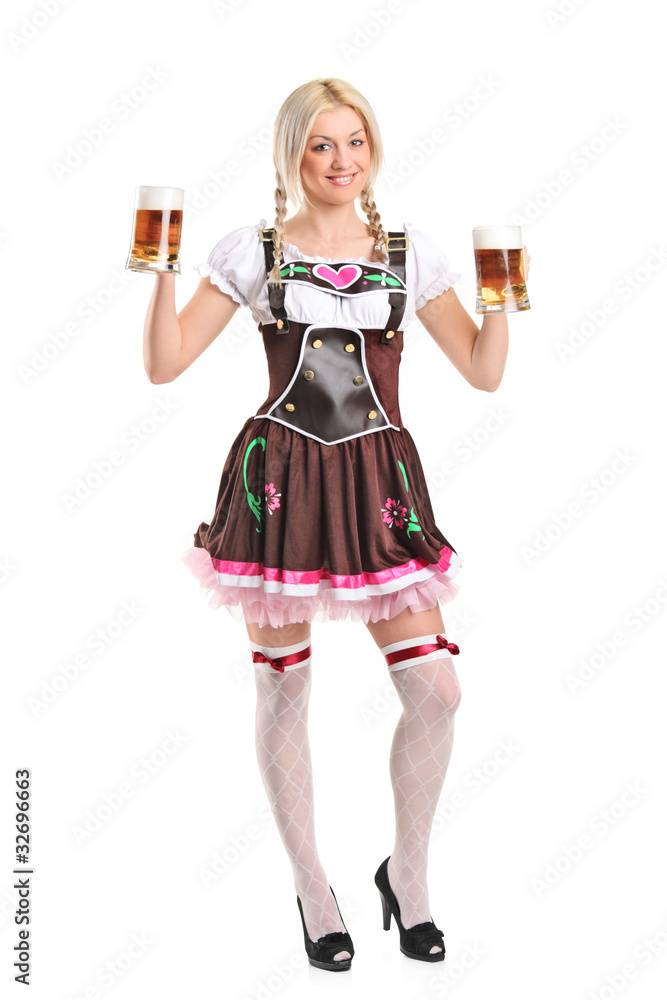 Blond woman with traditional costume holding beer glasses Blond woman with traditional costume holding beer glasses