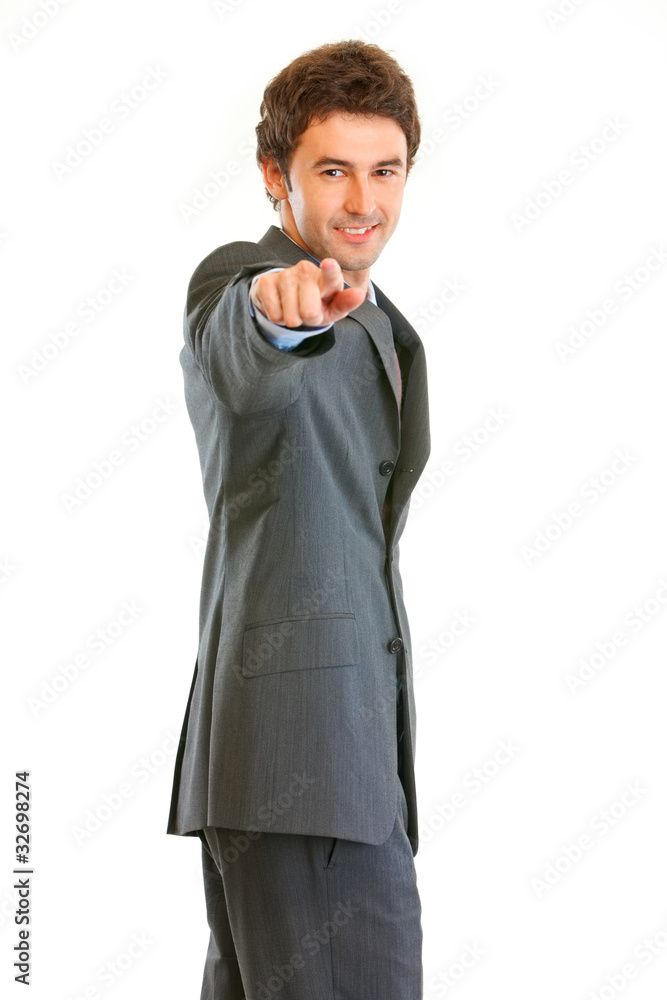Smiling businessman pointing finger at you isolated on white. Smiling businessman pointing finger at you isolated on white.