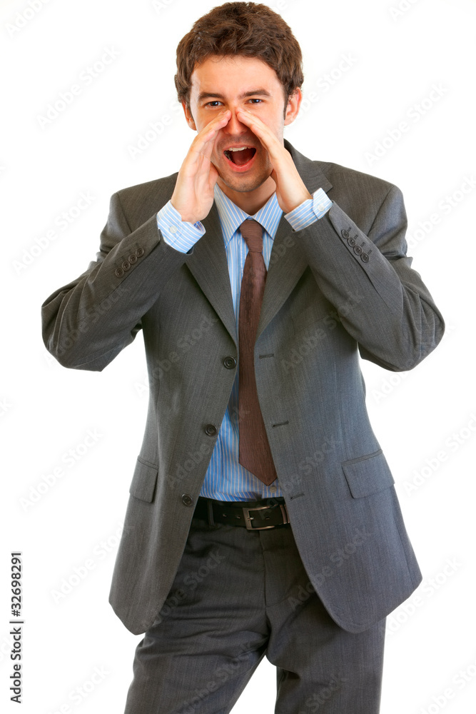 Businessman shouting through megaphone shaped hands Businessman shouting through megaphone shaped hands