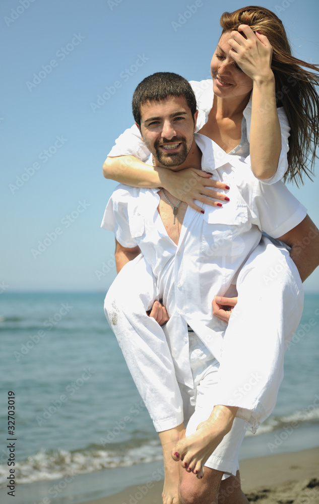 happy young couple have fun on beach