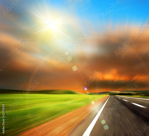 road and blured sky with sun