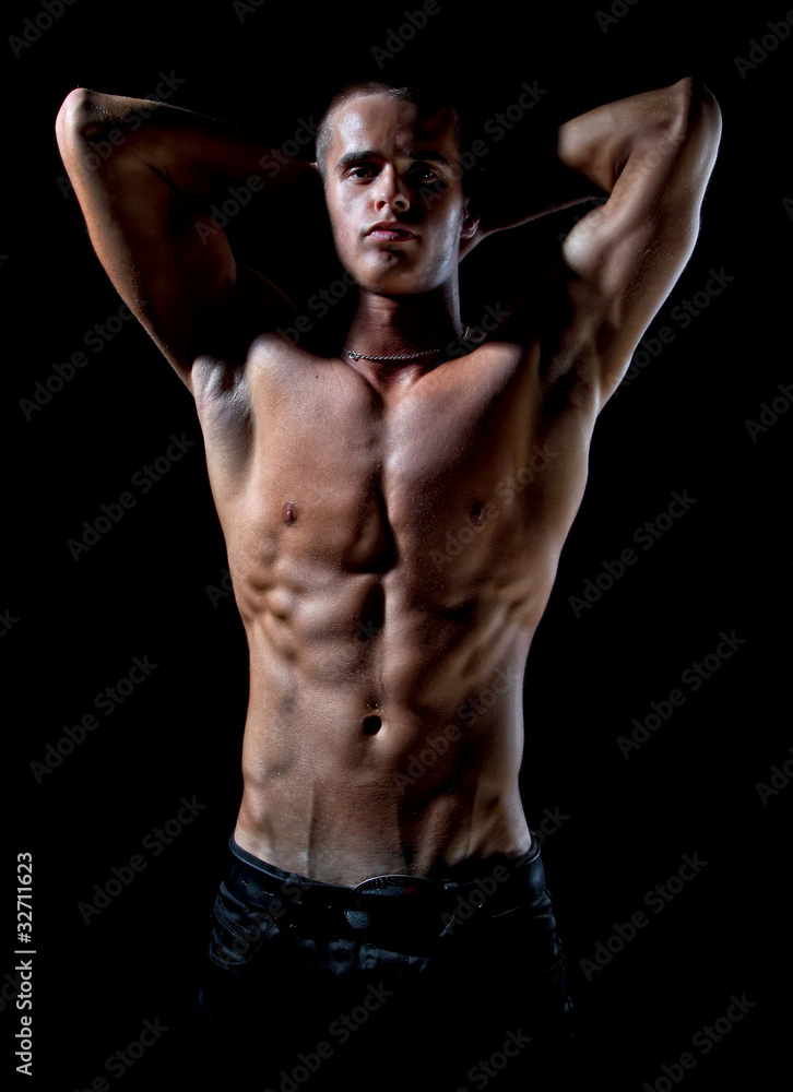 Fototapeta premium Muscle sexy wet naked young man posing in studio