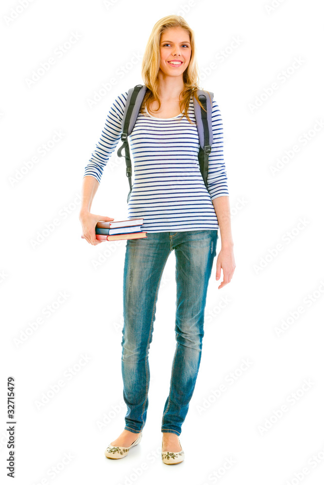 Smiling teengirl with schoolbag holding books in hand Smiling teengirl with schoolbag holding books in hand