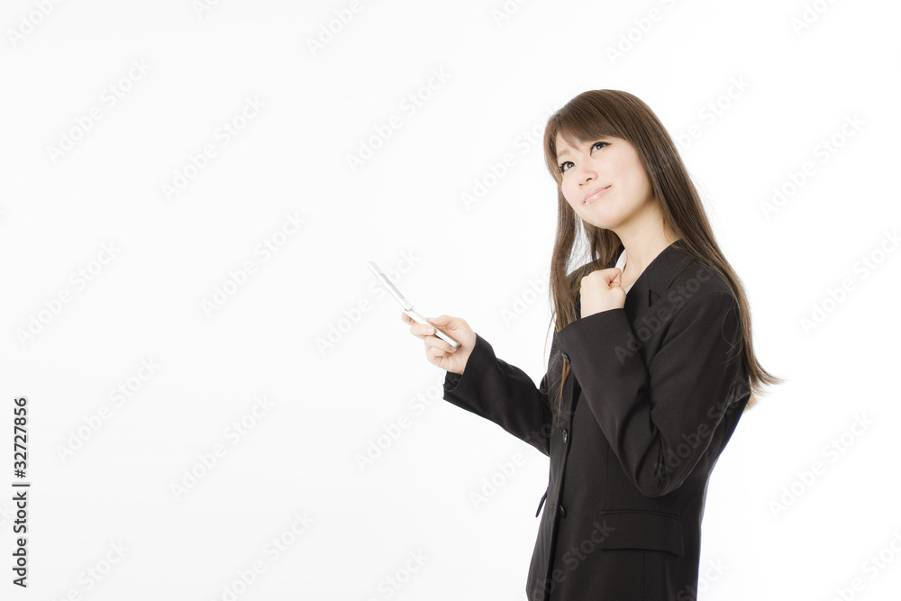 携帯電話とガッツポーズの女性社員 携帯電話とガッツポーズの女性社員