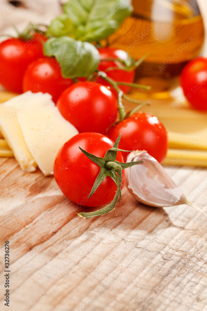 pasta, olive oil and tomatoes on the wood background pasta, olive oil and tomatoes on the wood background