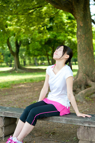 beautiful asian woman relaxing in the park